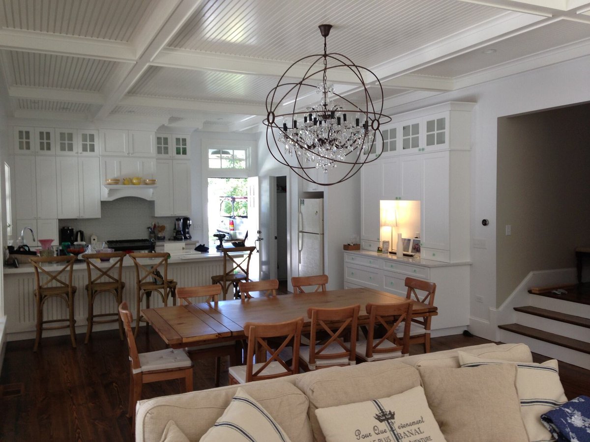 BelPort Building & Remodeling additions Barnstable MA open concept kitchen and dining area with custom cabinetry and chandelier