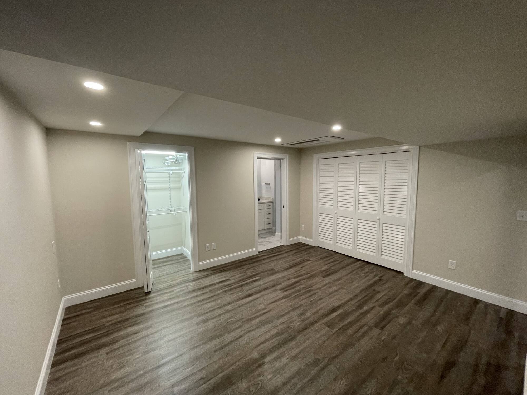 BelPort Building & Remodeling basement remodeling Hyannis MA finished basement bedroom with recessed lighting and closet space