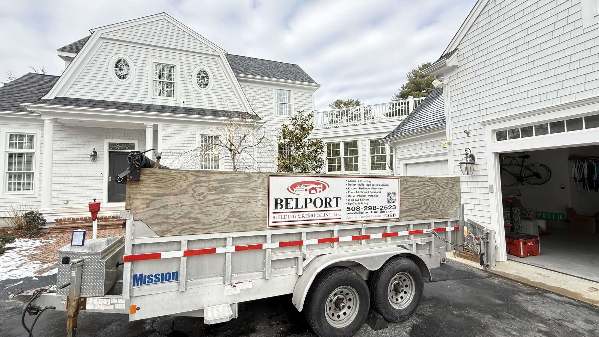 BelPort Building & Remodeling custom home Barnstable MA job site with trailer outside large custom home under construction