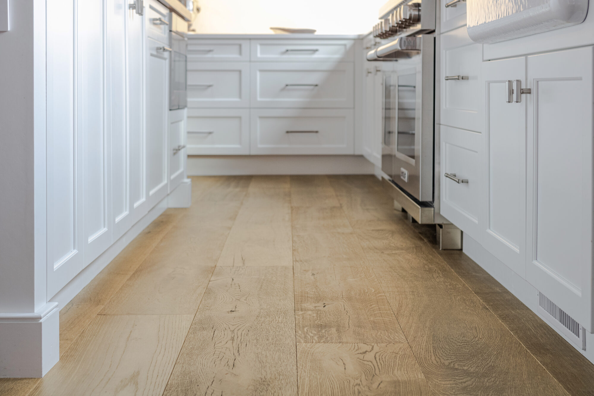 low angle view of new wood kitchen flooring by BelPort Building & Remodeling Forestdale MA
