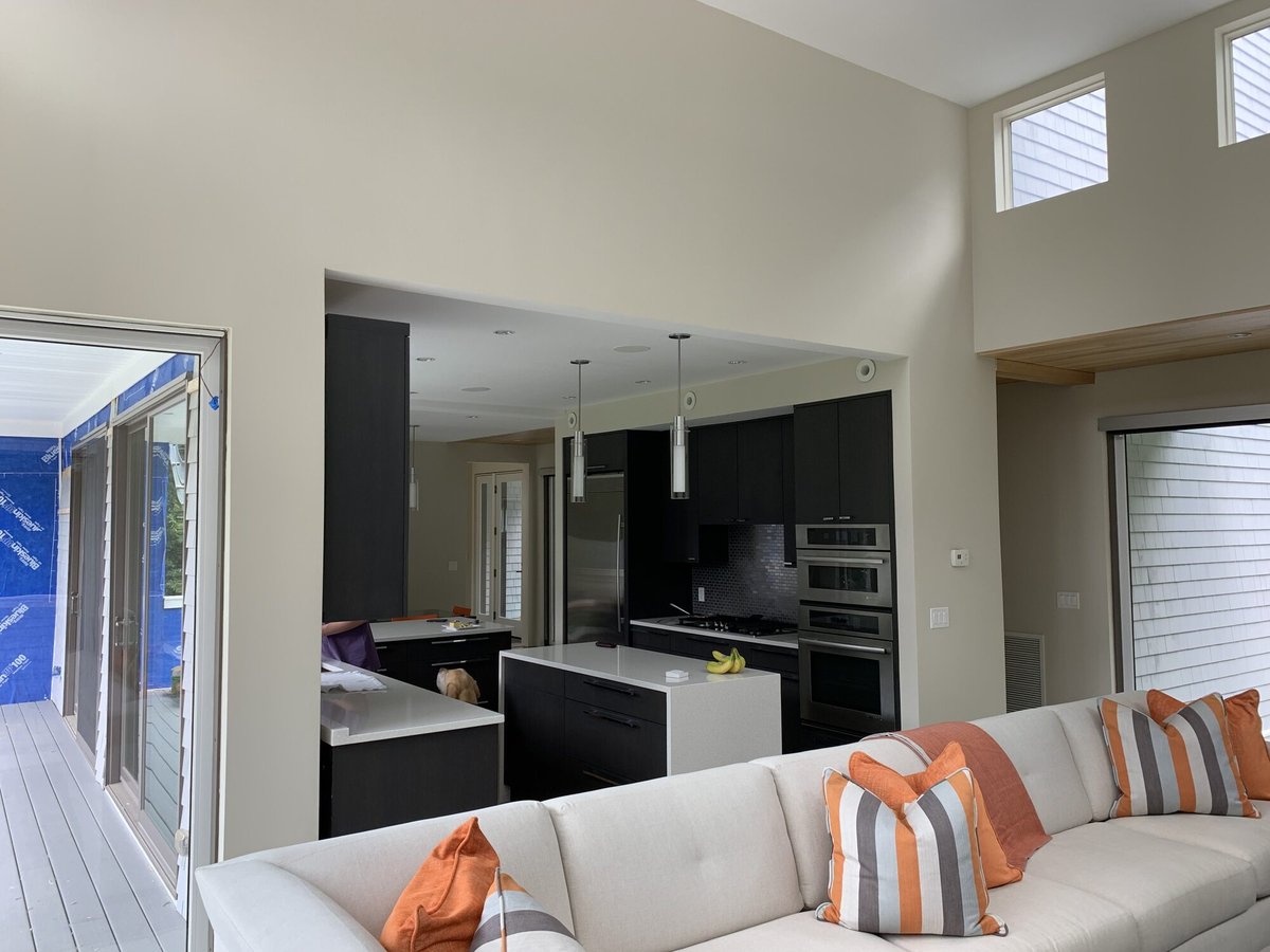 open concept living room and kitchen with modern finishes in Mashpee MA custom home by BelPort Building & Remodeling