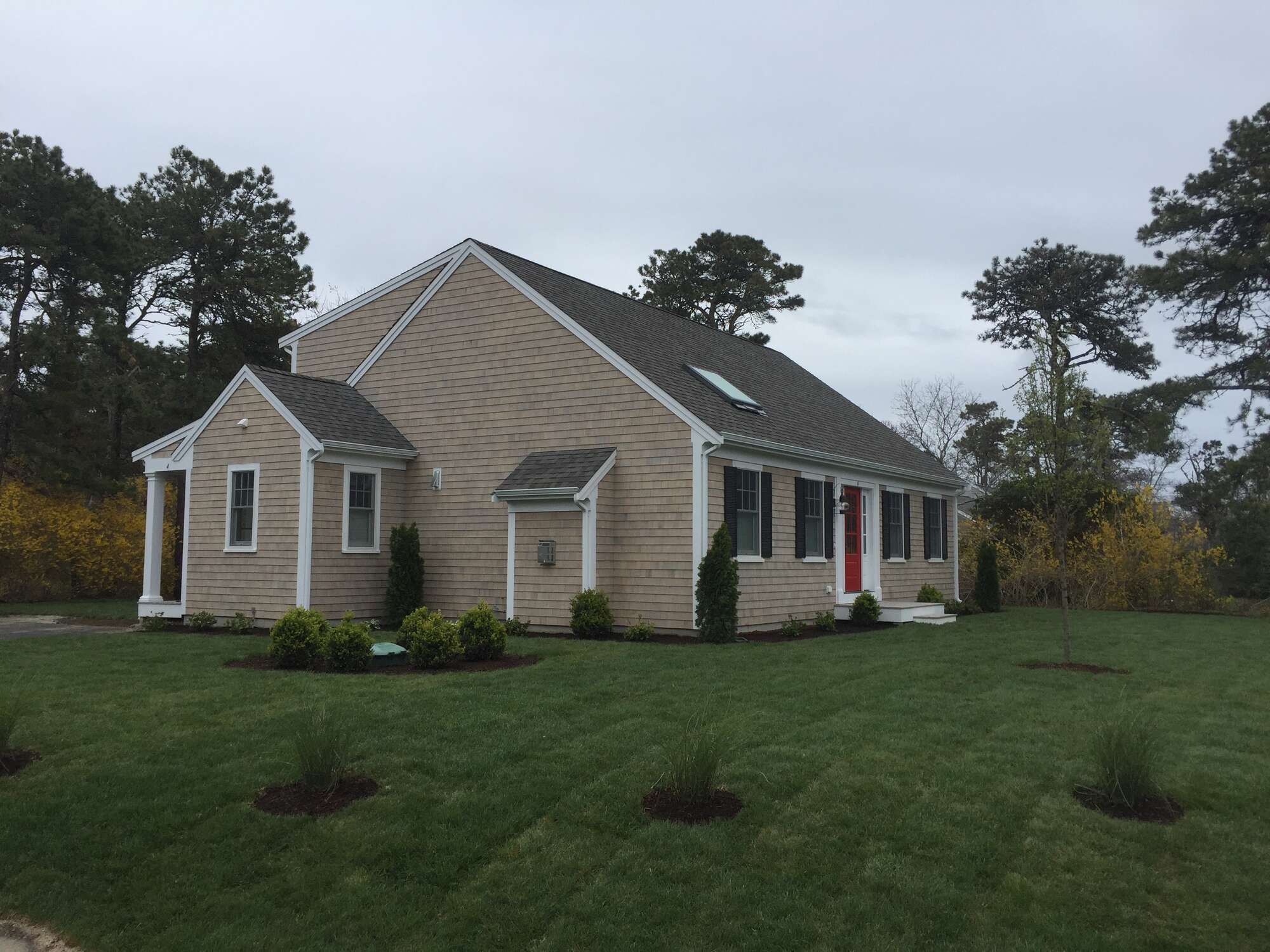 side view of completed custom home with landscaping in Chatham by BelPort Building & Remodeling
