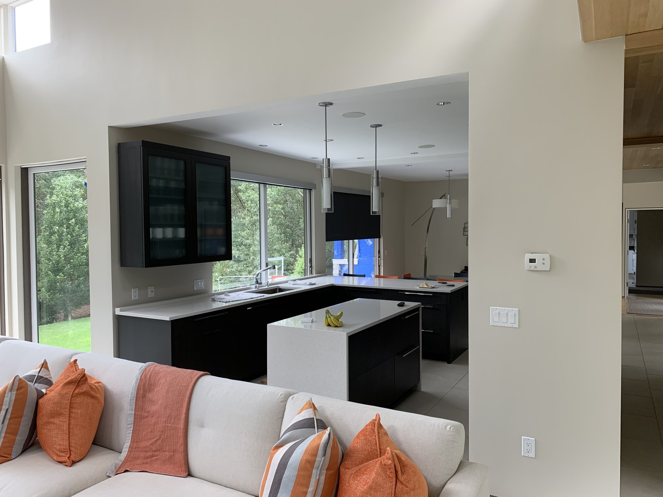 sleek kitchen design with large windows and island seating in Mashpee MA custom home by BelPort Building & Remodeling