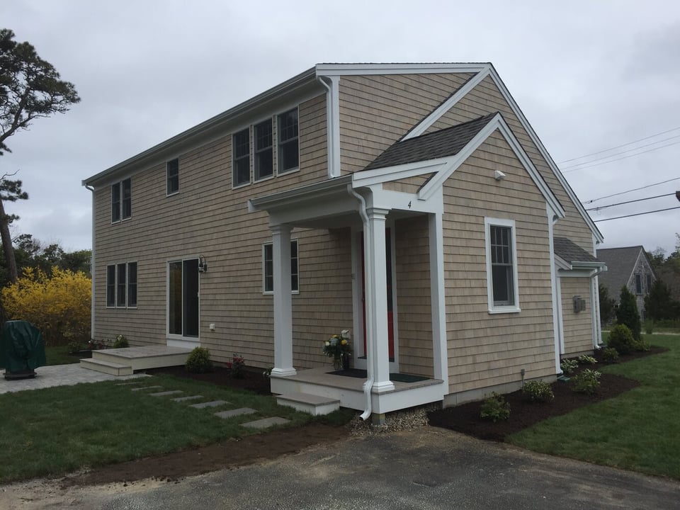 completed home exterior with entryway and landscaping in Chatham by BelPort Building & Remodeling