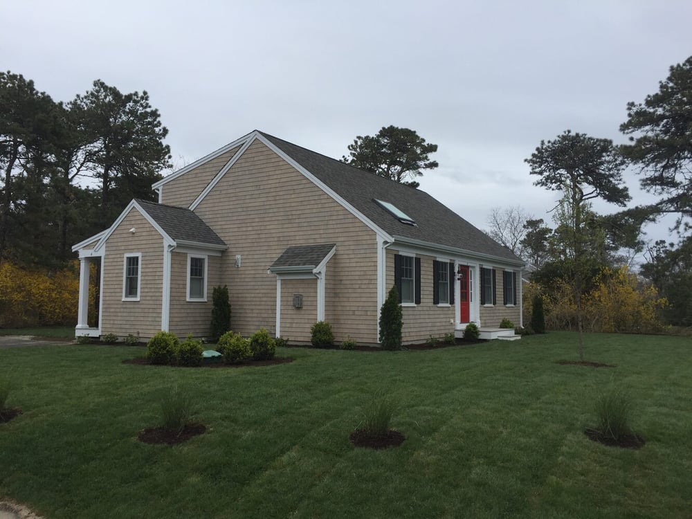 side view of completed custom home with landscaping in Chatham by BelPort Building & Remodeling