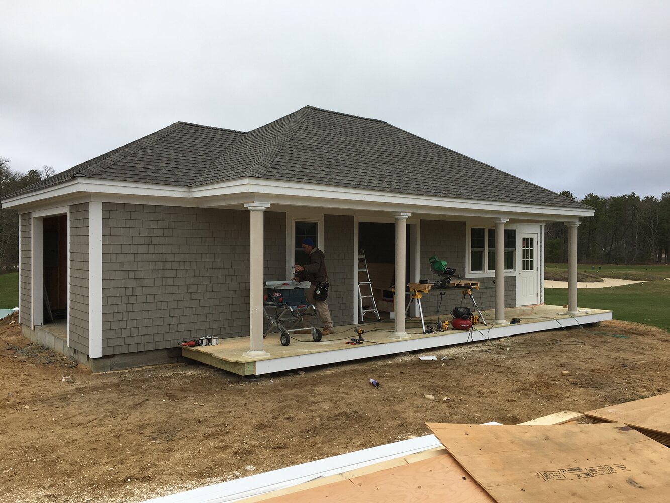 BelPort Building & Remodeling custom home exterior with siding and porch columns under construction in New Seabury, MA progress