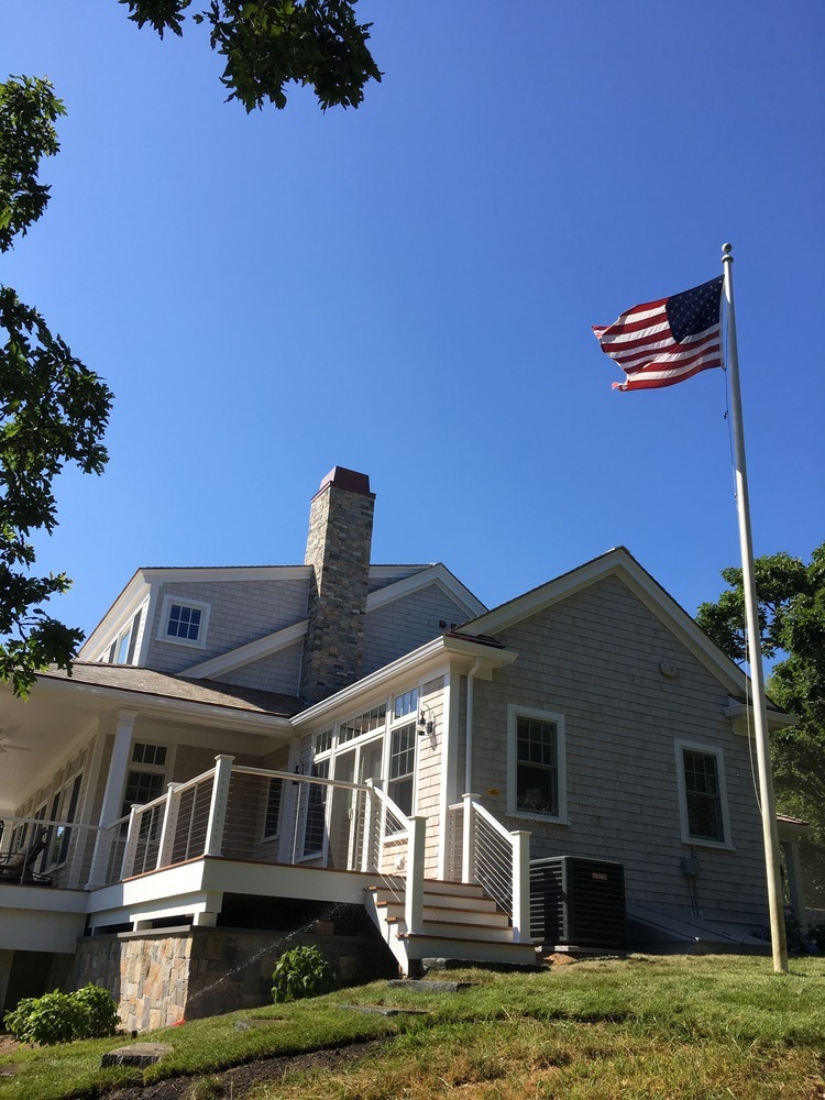 BelPort Building & Remodeling outdoor living deck and railing with American flag view in Sandwich, MA BelPort Building & Remodeling outdoor living deck and railing with American flag view in Sandwich, MA