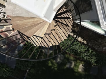 curved exterior staircase with wood treads and metal railing for outdoor living in Barnstable, MA