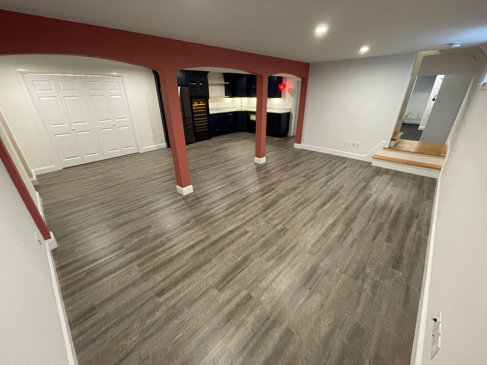BelPort Building & Remodeling basement remodeling Hyannis MA finished basement living area with open floor plan and vinyl flooring