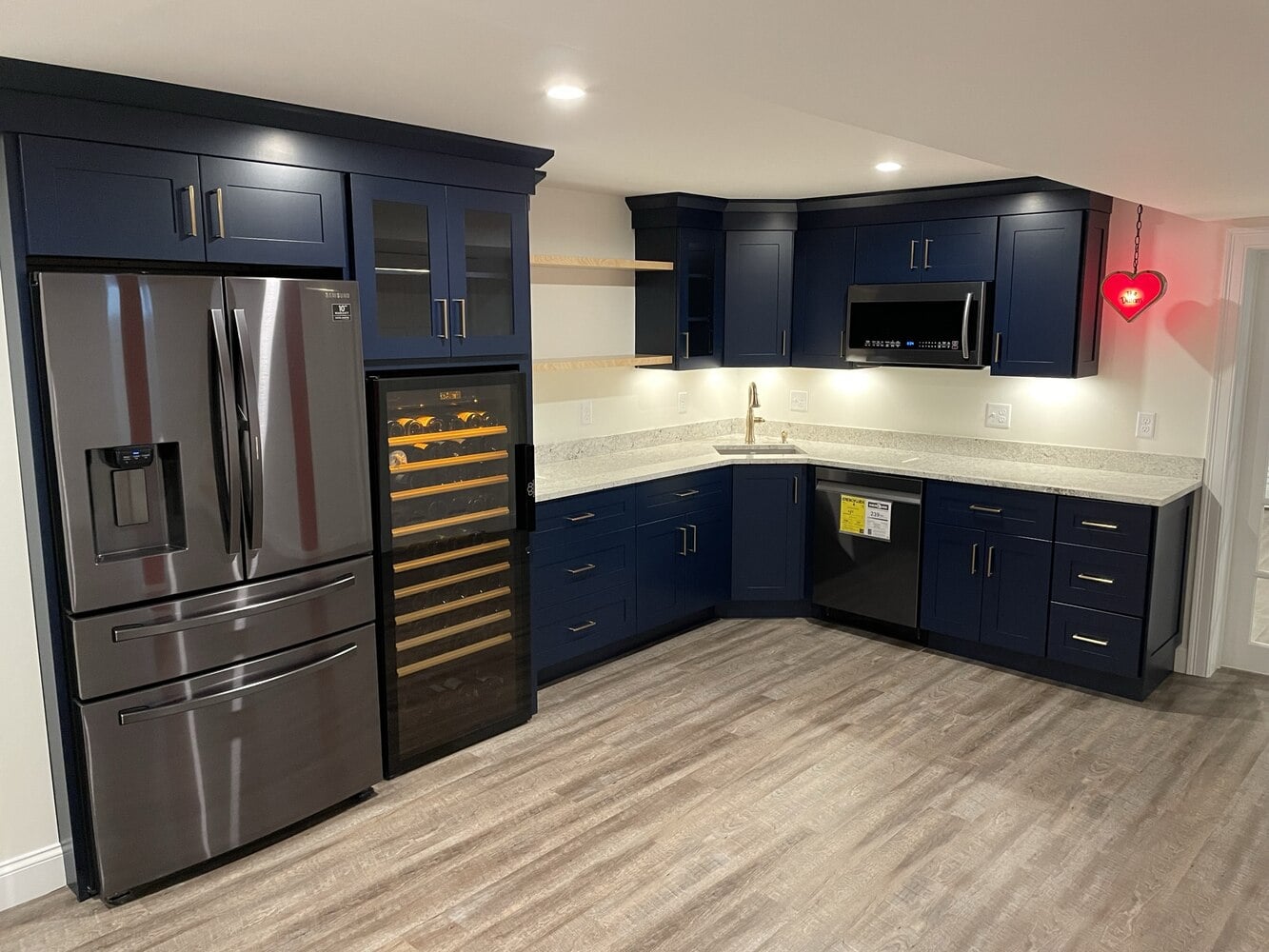 BelPort Building & Remodeling basement remodeling Hyannis MA finished basement bar area with blue cabinetry and wine fridge