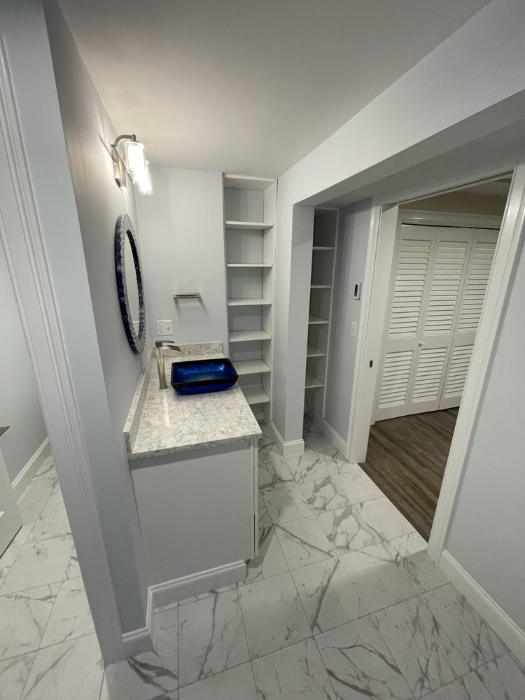 BelPort Building & Remodeling basement remodeling Hyannis MA finished basement bathroom vanity and storage shelving area