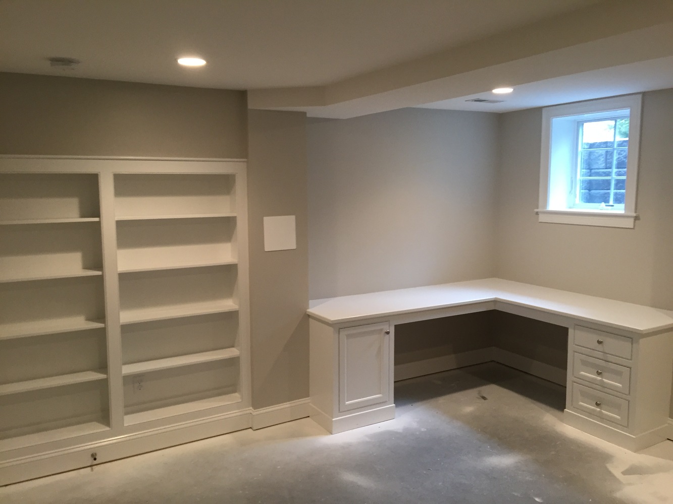 BelPort Building & Remodeling custom basement office with built-in desk and shelving in Chatham, MA