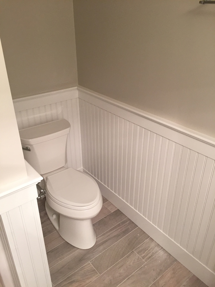 BelPort Building & Remodeling finished basement bathroom vanity with lighting and cabinetry in Chatham, MA