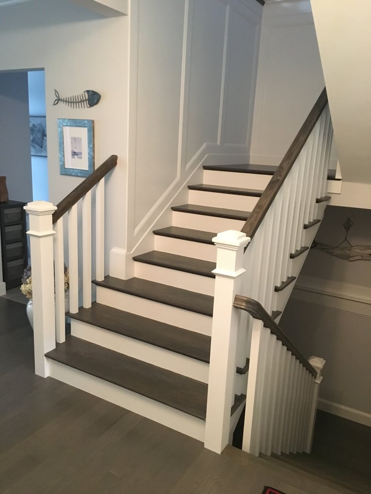 finished staircase with modern wood steps and trim detail in Chatham custom home by BelPort Building & Remodeling