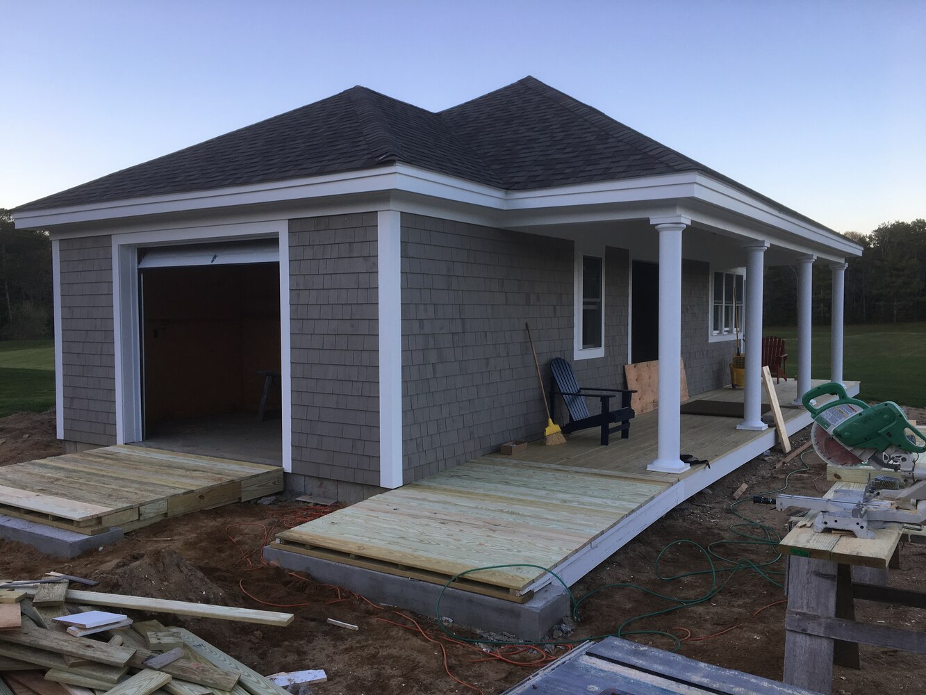BelPort Building & Remodeling custom home exterior with garage and porch under construction in New Seabury, MA progress
