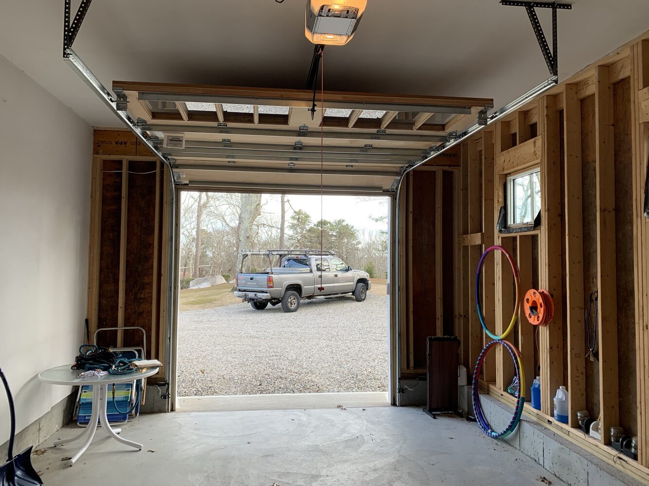 garage under construction with framing and open entry before completion in Barnstable by BelPort Building & Remodeling progress