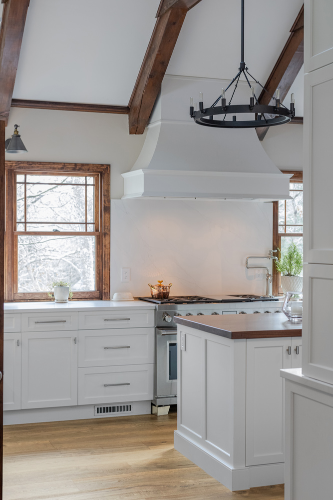 BelPort Building & Remodeling kitchen remodeling in Forestdale MA showing range hood and window-lined cooking area