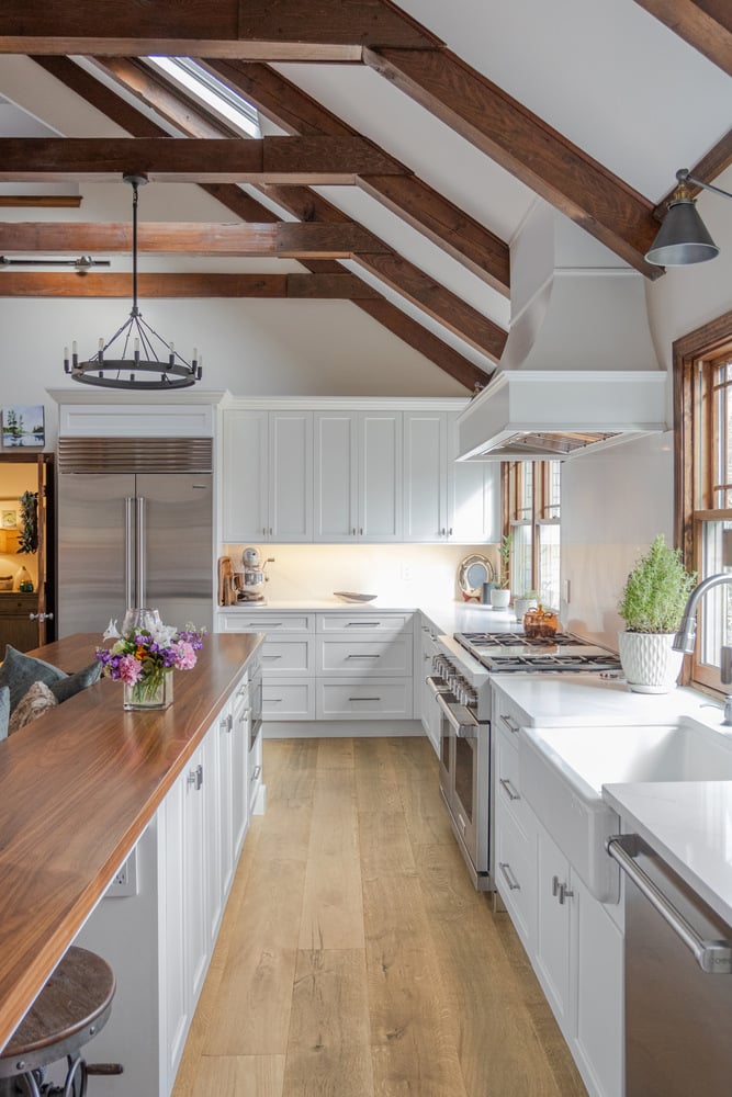 BelPort Building & Remodeling kitchen remodeling in Forestdale MA with white cabinets wood beams and large island